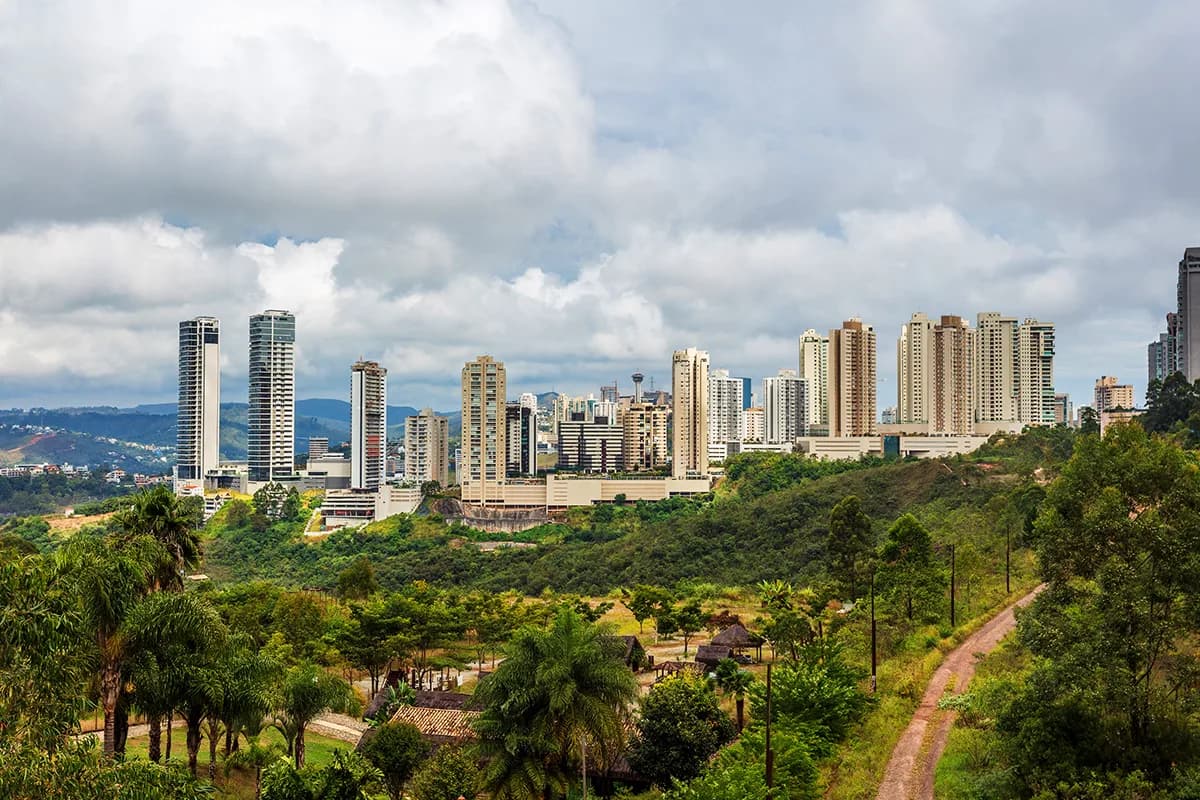Panorama di una città brasiliana con grattacieli, colline e vegetazione tropicale, da scoprire durante un anno all’estero in Brasile